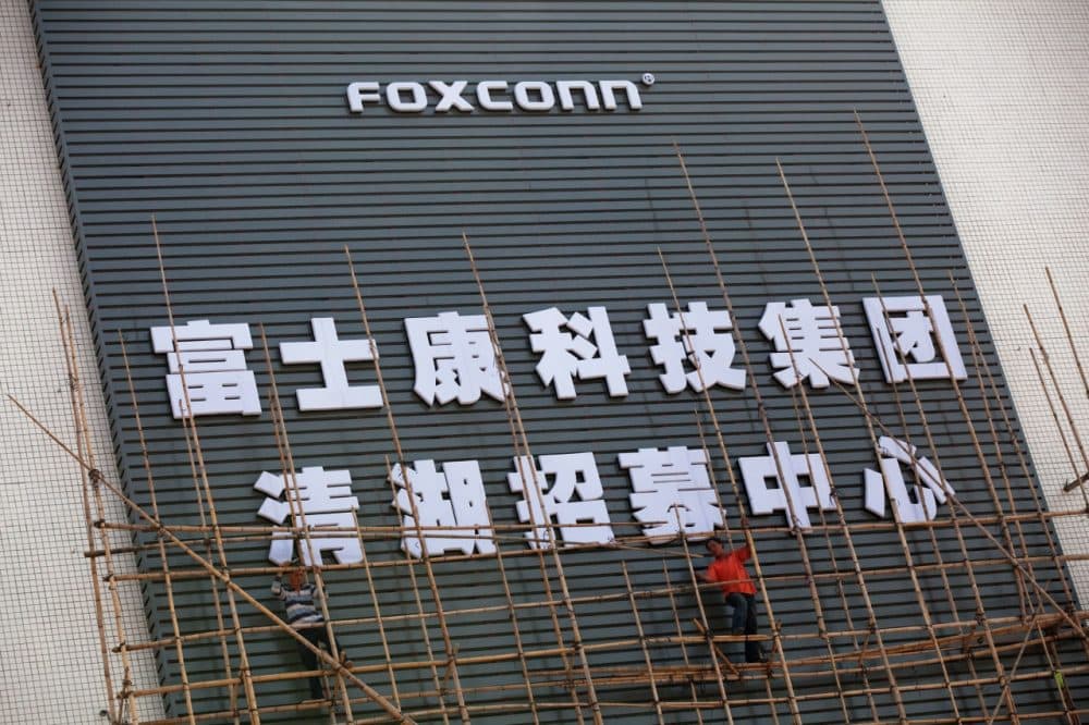 Workers put up scaffolding on a building owned by the contract manufacturer Foxconn International Holdings Ltd on November 28, 2010 in Shenzhen, China. (Daniel Berehulak/Getty Images)