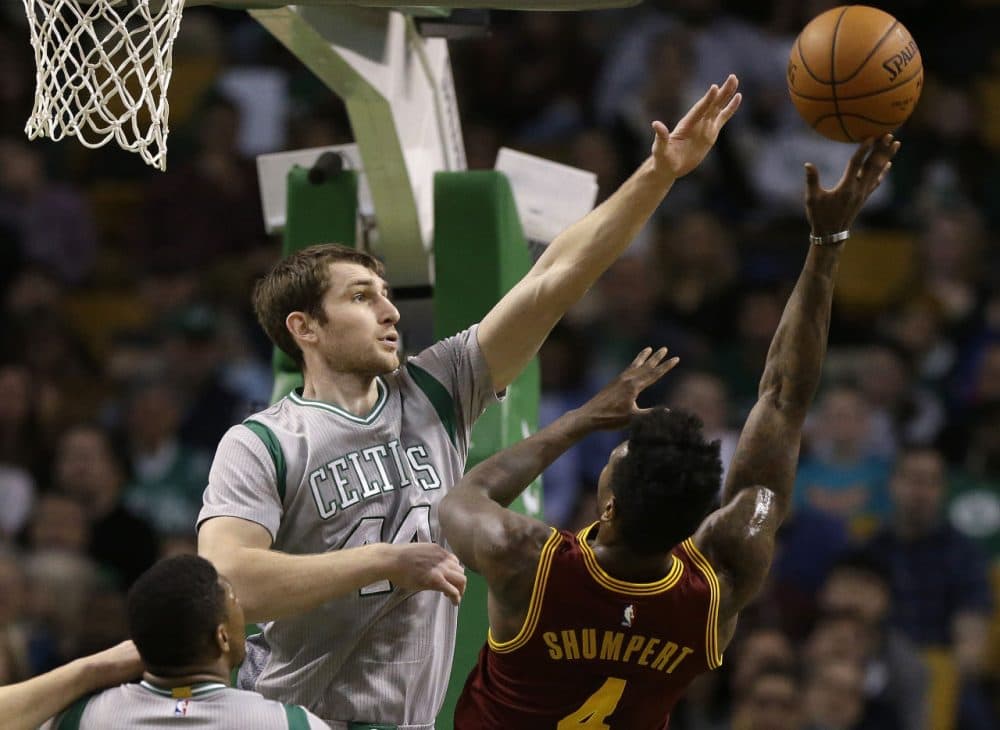 Boston Celtics center Tyler Zeller, left, reaches to block a shot by Cleveland Cavaliers guard Iman Shumpert. (Steven Senne/AP)