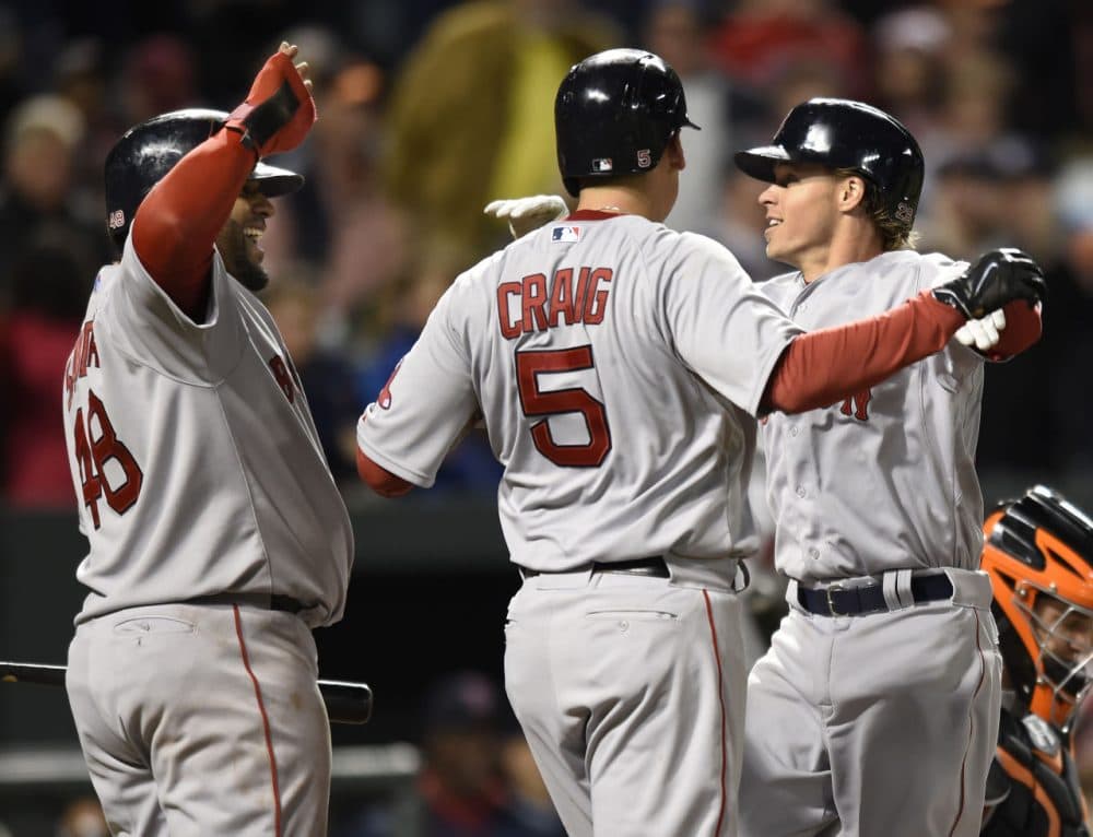 Red Sox's Brock Holt, right, celebrates his three run home run with Allen Craig, center, and Pablo Sandoval in the eighth inning against the Orioles, Friday, April 24, 2015, in Baltimore. (AP Photo/Gail Burton)