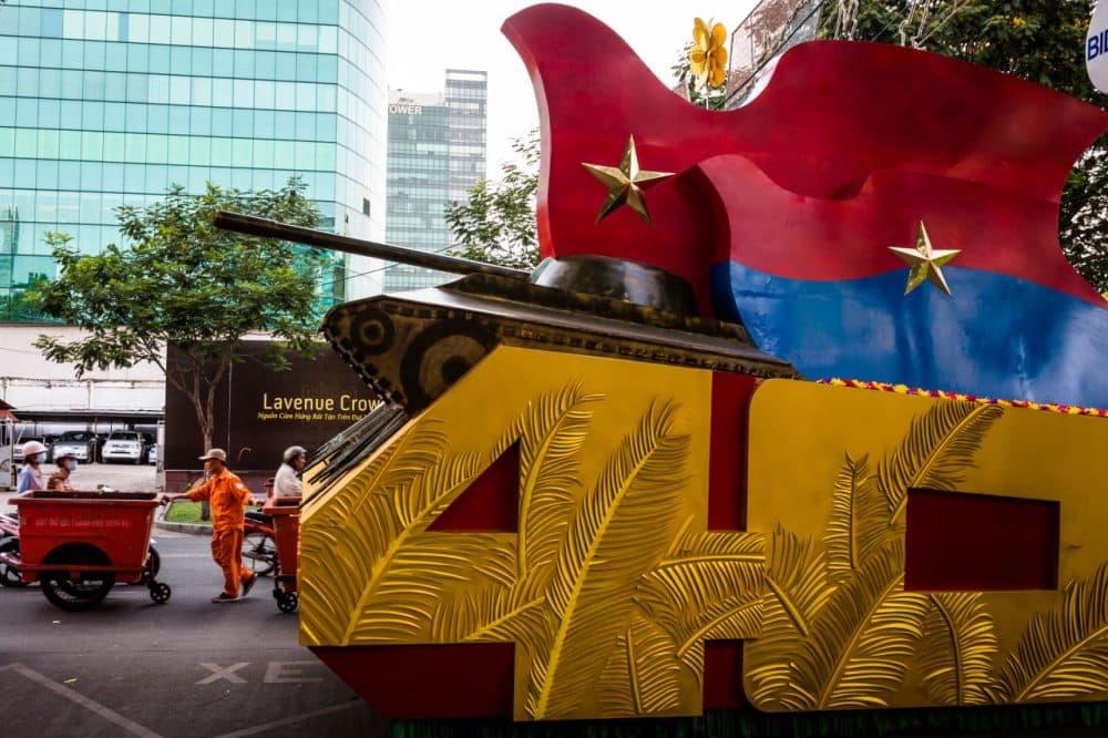 Daily work and life goes on as preparations are made for a large parade to celebrate 40 years since the fall of Saigon. (Quinn Ryan Mattingly for WBUR)