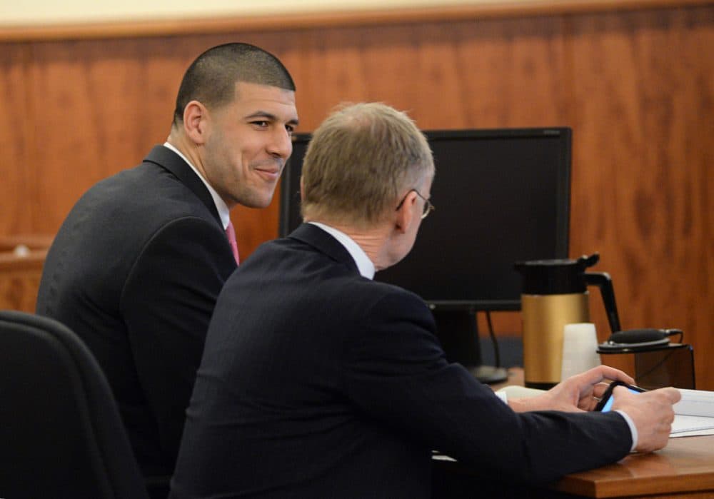 Aaron Hernandez talks with his defense attorney Wednesday. (Faith Ninivaggi/AP/Pool)