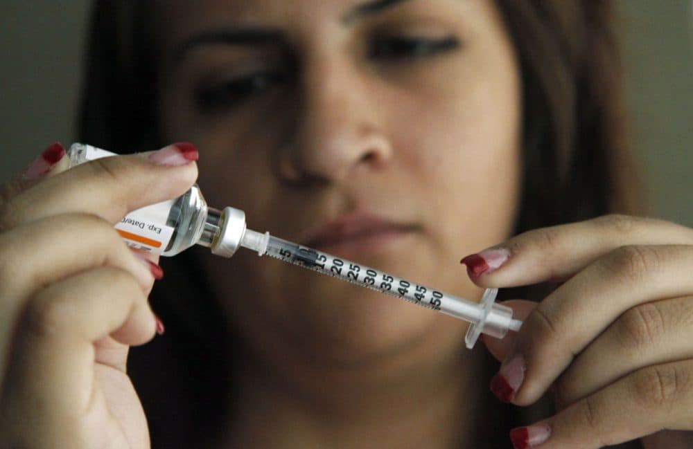 Judith Garcia, 19, fills a syringe as she prepares to give herself an injection of insulin at her home in Commerce, Calif., on April 29, 2012. (Reed Saxon/AP)