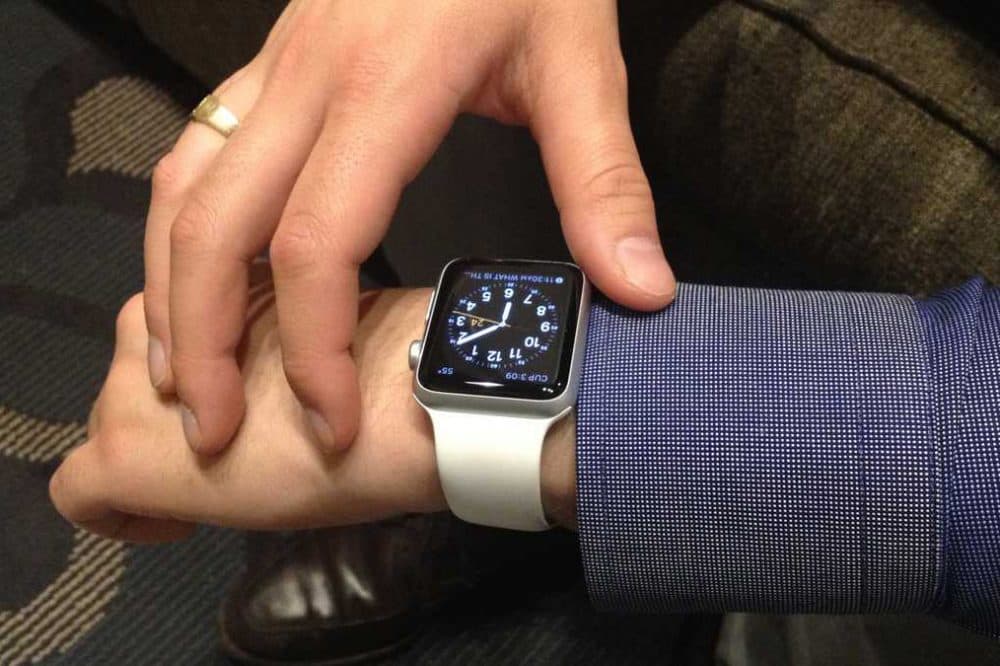 Sunkwon Bush sets up his new Apple Watch after its arrival last Friday at the Center City Philadelphia offices of Think Brownstone. (Carolyn Beeler/WHYY)