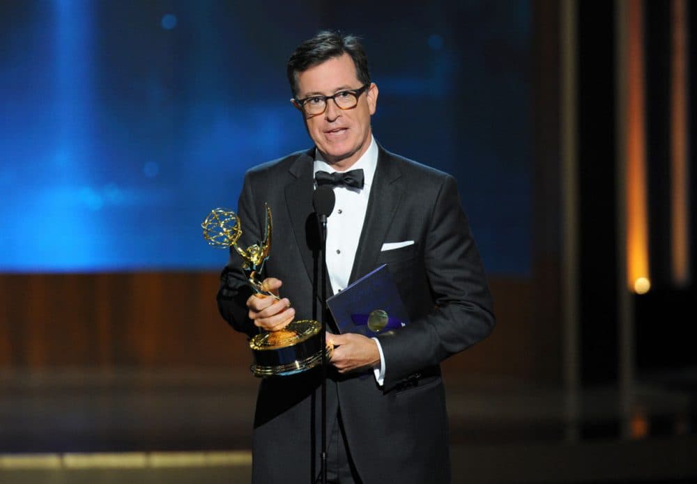 Stephen Colbert accepts the award for outstanding supporting actor in a miniseries or a movie on behalf of Martin Freeman for his work on Sherlock: His Last Vow (Masterpiece) at the 66th Primetime Emmy Awards. (Vince Bucci/Invision for the Television Academy/AP)