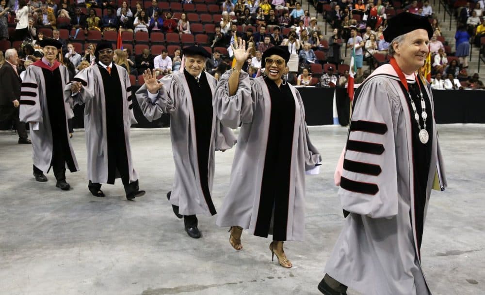 Berklee College of Music president Roger Brown walks to the dais followed by honorary degree recipient jazz vocalist Dee Dee Bridgewater. (Michael Dwyer/AP)