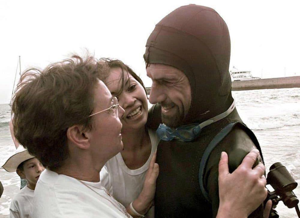French swimmer Benoit "Ben" Lecomte (right) is greeted on September 25, 1998, on the beach of Port-Maria in Quiberon by his girlfriend Tinny (center) and his mother Liliane (left), after swimming across the Atlantic, from the United States to France. (Marcel Mochet/AFP/Getty Images)