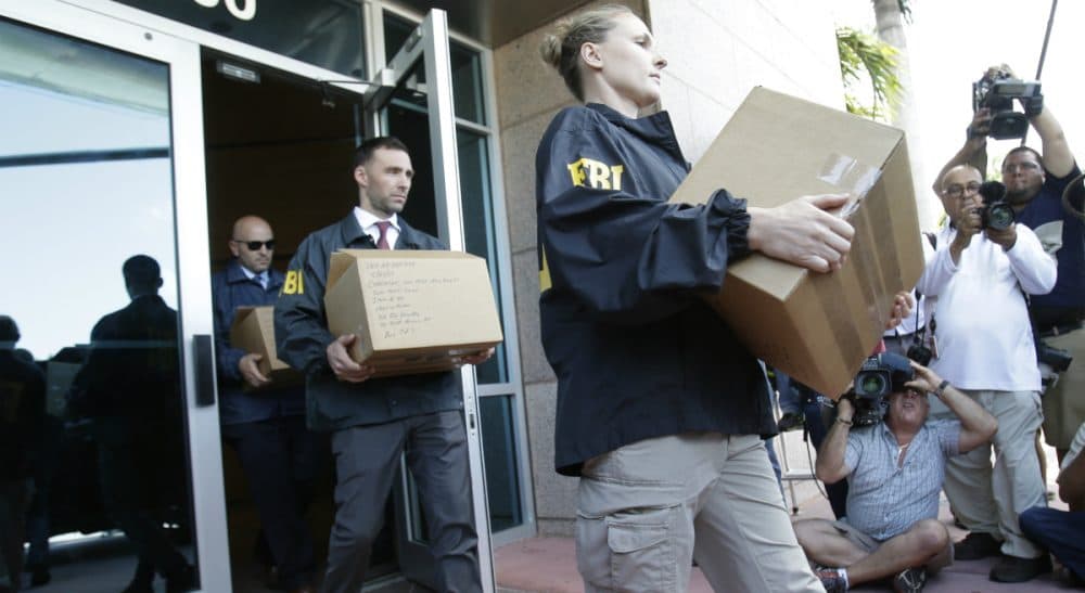 Federal agents load a van with boxes of evidence taken from the headquarters of the Confederation of North, Central America and Caribbean Association Football (CONCACAF,) Wednesday, May 27, 2015, in Miami Beach, Fla. Swiss prosecutors opened criminal proceedings into FIFA's awarding of the 2018 and 2022 World Cups, only hours after seven soccer officials were arrested Wednesday pending extradition to the U.S. in a separate probe of "rampant, systemic, and deep-rooted" corruption. (Wilfredo Lee/AP)