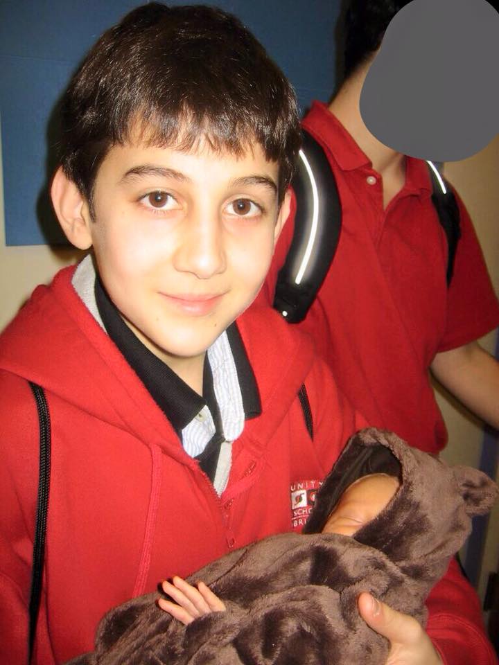 Before Dzhokhar Tsarnaev was the convicted Boston Marathon bomber, he was Becki Norris’ student. Tsarnaev is pictured here holding the author's newborn daughter in an undated photo. (Courtesy)