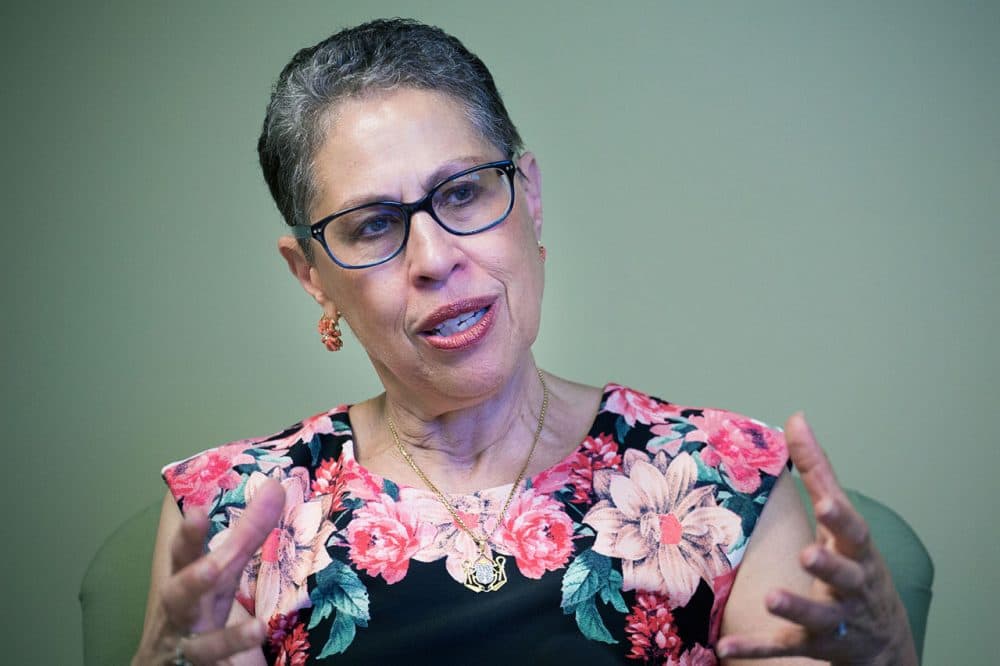 Former director of the Massachusetts Life Sciences Center Susan Windham-Bannister sitting at her desk in Waltham. (Jesse Costa/WBUR)