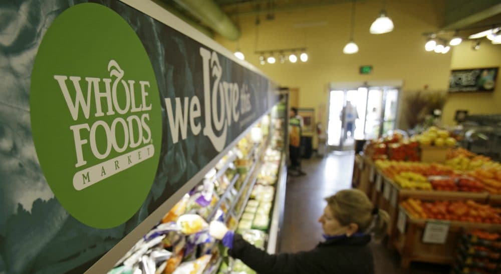The upscale grocer practices "conscious capitalism," but its workers and others still need programs like Obamacare. (Tony Dejak/AP)