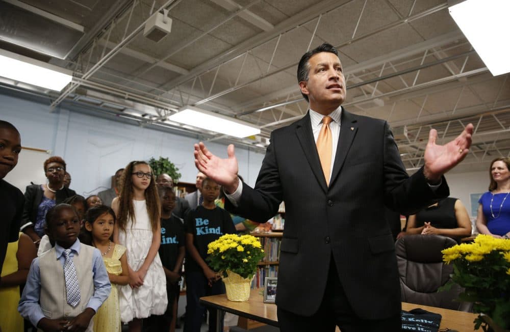 Nevada Governor Brian Sandoval, right, holds a bill signing ceremony Wednesday, June 3, 2015, in Las Vegas. (John Locher/AP)