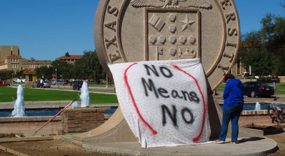Harvey Silverglate: Massachusetts should pass the “right to counsel” bill to reflect the reality of shadow criminal justice systems on our campuses. In this Wednesday, Oct. 1, 2014 file photo, a student at Texas Tech helps drape a bed sheet with the message "No Means No" over the university's seal to protest what students say is a "rape culture" on campus. (Betsy Blaney/AP)