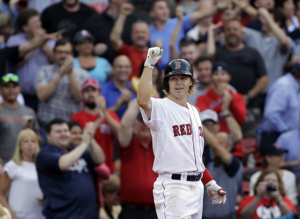 Boston Red Sox's Brock Holt gestures after hitting a triple in the eighth inning of the game against the Atlanta Braves at Fenway Park Tuesday, June 16, 2015. Holt hit for the cycle, the first Sox player to do so in 19 years. (Elise Amendola/AP)