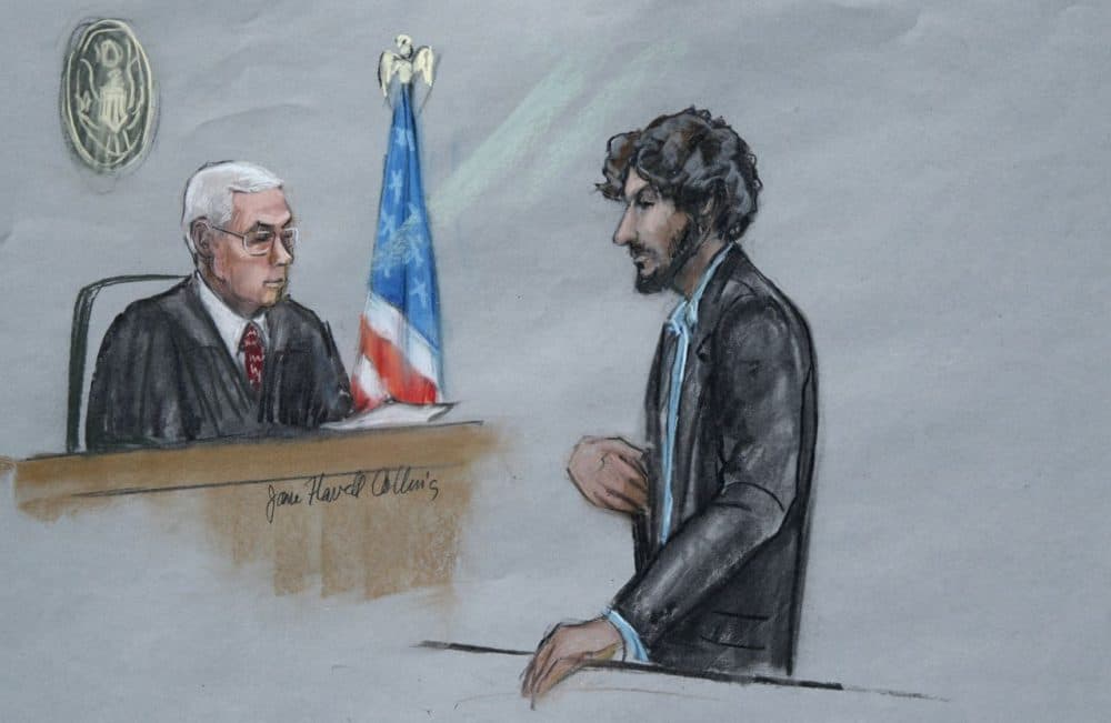 In this courtroom sketch, Boston Marathon bomber Dzhokhar Tsarnaev stands before U.S. District Judge George O'Toole Jr. as he addresses the court during his sentencing. Tsarnaev apologized to the victims and their loved ones for the first time, just before the judge formally sentenced him to death. (Jane Flavell Collins/AP)