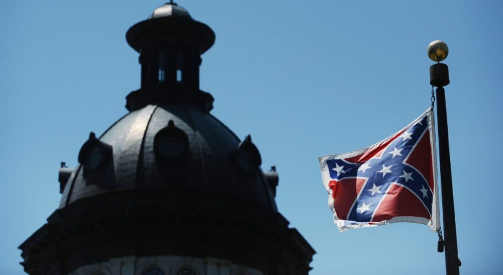 In this Friday, June 19, 2015 file photo, the Confederate flag flies near the South Carolina Statehouse, in Columbia. For years, lawmakers refused to consider removing the Confederate flag from Statehouse grounds, but opinions changed within days of the massacre of nine people at Emanuel African Methodist Episcopal church in Charleston. (Rainier Ehrhardt/AP)