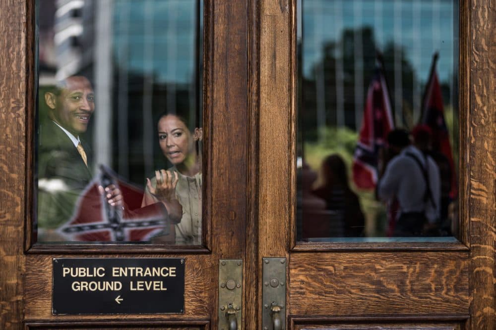People inside the capitol building watch as Confederate flag supporters gather at the state house July 6, 2015 in Columbia, South Carolina. (Sean Rayford/Getty Images)