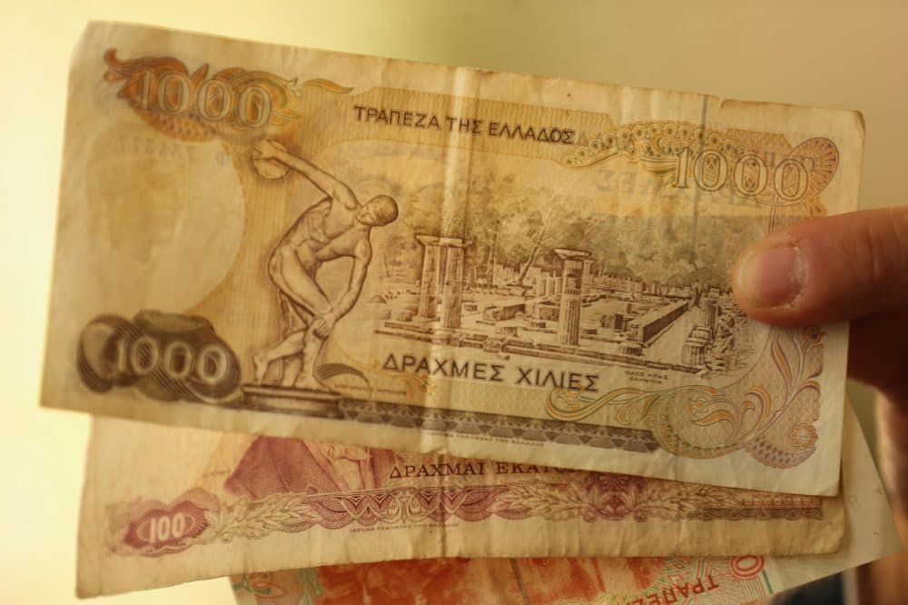 A man holds drachma notes, the currency in Greece before the euro, on July 7, 2015 in Athens, Greece. (Christopher Furlong/Getty Images)