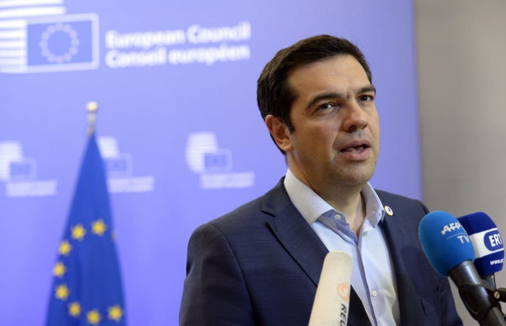 Greek Prime Minister Alexis Tsipras talks to the media at the end of an Eurozone Summit over the Greek debt crisis in Brussels on July 13, 2015. Juncker said there was no longer any risk of Greece crashing out of the euro after Athens agreed a bailout deal with eurozone partners. (Theirry Charlier/Getty Images)