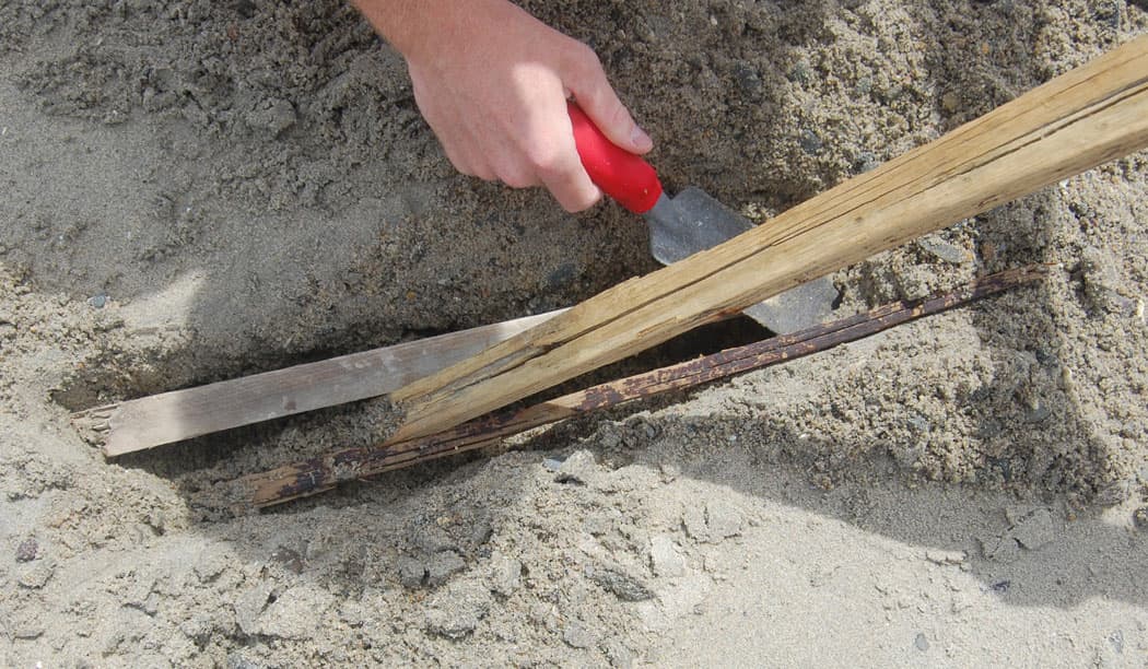 Shimmying in smaller sticks at the base of the support sticks. (Greg Cook)