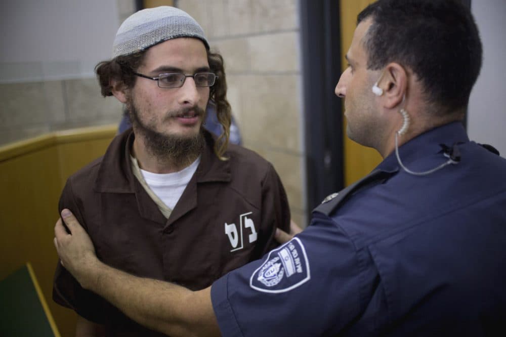 Meir Ettinger appears in court in Nazareth Illit, Israel, on Tuesday, Aug. 4, 2015. Israel said Tuesday it was interrogating Ettinger, the suspected head of a Jewish extremist group, in the first arrest of an Israeli suspect following last week's arson attack in the West Bank that killed a Palestinian toddler and wounded his brother and parents. (Ariel Schalit/AP)