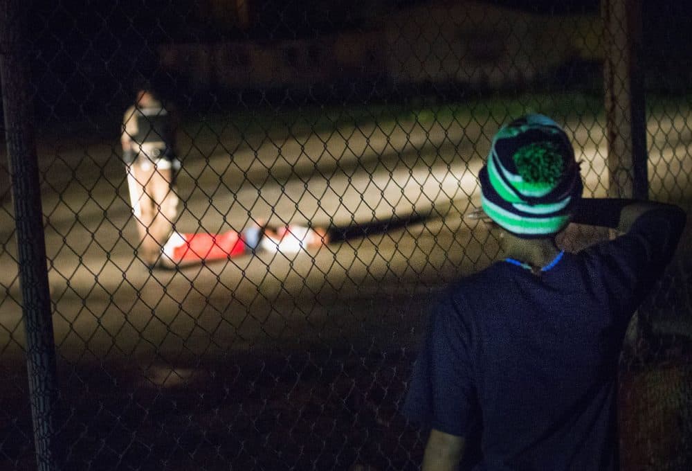 A young boy looks at a man with gunshot wounds lying in a parking lot after a shoot out with police along West Florissant Street during a demonstration to mark the one-year anniversary of the shooting of Michael Brown on Sunday in Ferguson, Missouri. The shooter is listed in critical condition in an area hospital. Michael Brown's death sparked months of sometimes violent protests in Ferguson and drew nationwide focus on police treatment of black offenders. (Scott Olson/Getty Images)