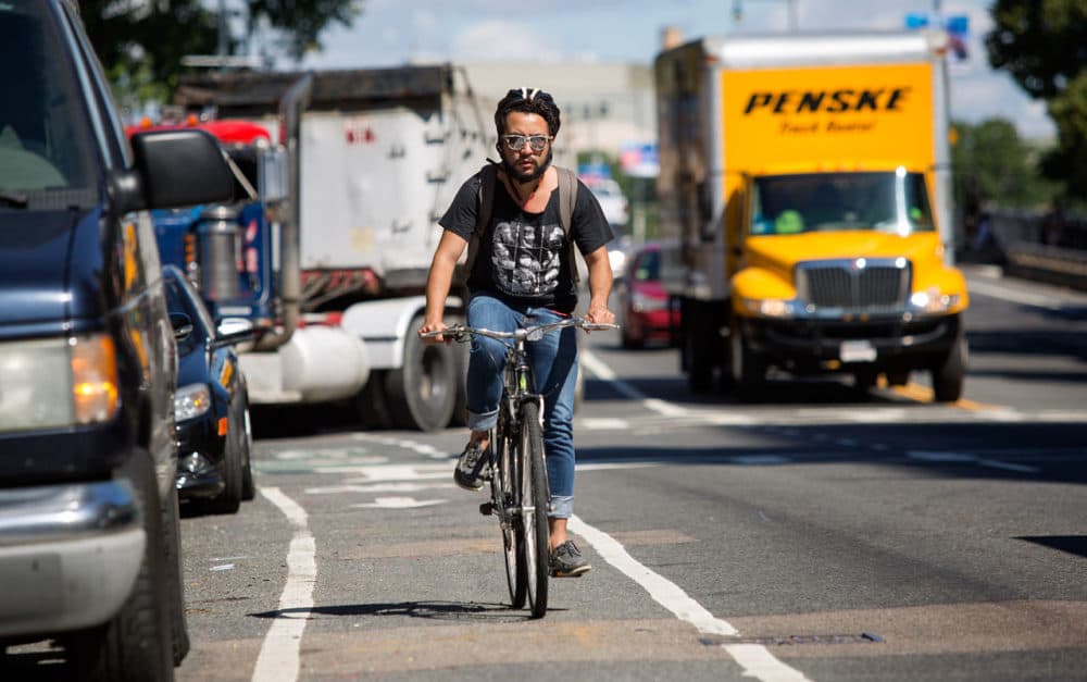 A bicyclist rides along the bicycle lane on Massachusetts Avenue. (Robin Lubbock/WBUR)