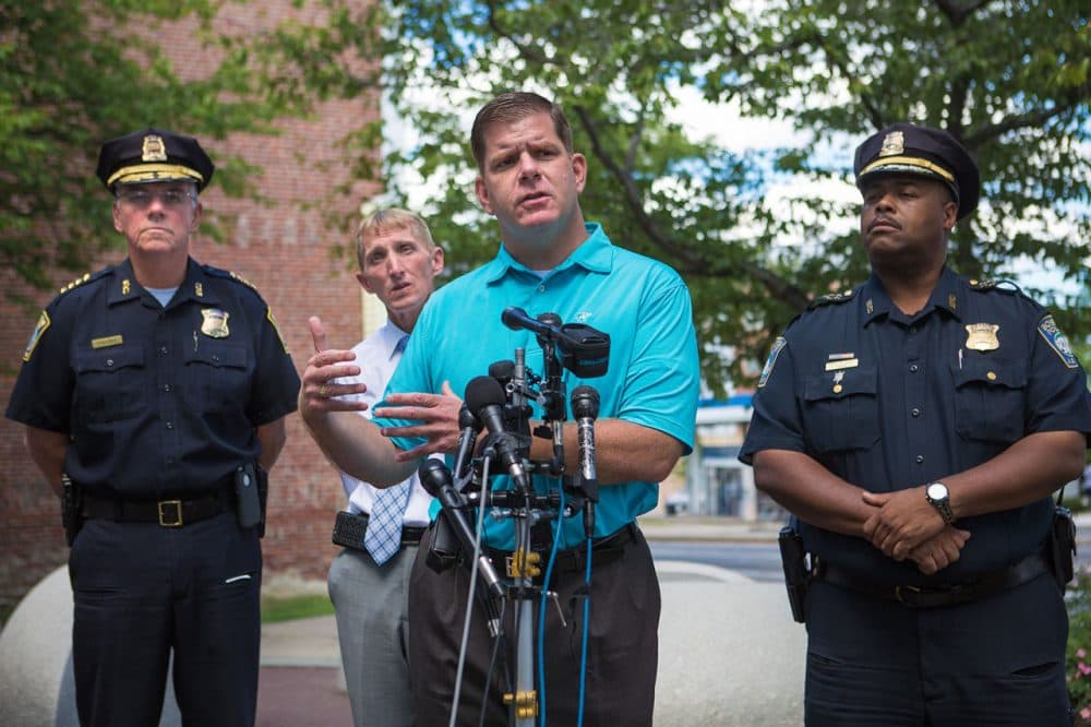 Boston Mayor Marty Walsh speaks Thursday in Roxbury about shootings that left three dead in the city. He's flanked by Boston Police Department officials. (Jesse Costa/WBUR)