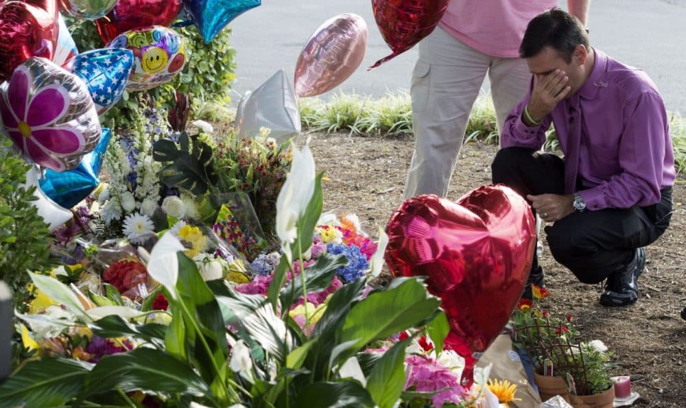 WDBJ TV weatherman Leo Hirshbrunner views the makeshift memorial with members of the crew at the gate of WDBJ's television studios August 27, 2015, in Roanoke, Virginia. The former television reporter who shot dead two journalists during a live broadcast before killing himself warned he had been a 'human powder keg... just waiting to go BOOM.' The gunman -- Vester Lee Flanagan, 41, also known as Bryce Williams --posted chilling footage of Wednesday's shocking double murder online. Reporter Alison Parker, 24, and cameraman Adam Ward, 27, were shot and killed at close range while conducting an on-air interview for WDBJ, a CBS affiliate in Roanoke, Virginia, about 240 miles southwest of Washington. Friends, family and the community at large mourned the tragedy, which renewed calls for tougher gun laws in the United States. Flanagan was said to have bought his gun legally. (Paul J. Richards/AFP/Getty Images)