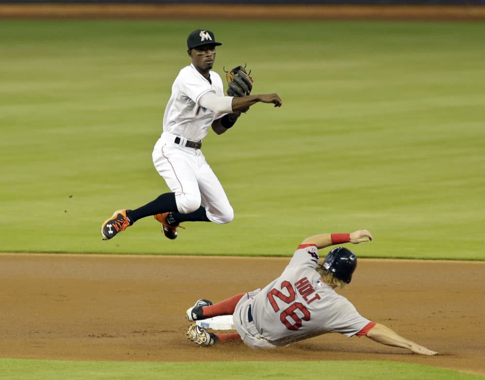 Boston Red Sox's Brock Holt (26) is forced out at second base as Miami Marlins second baseman Dee Gordon (9) throws out Xander Bogaerts at first base to complete a duoble play in the first inning of a baseball game, on Wednesday in Miami. (Alan Diaz/AP)