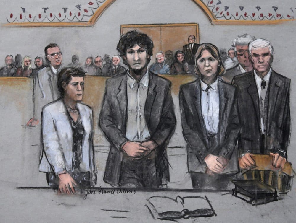 In this May 2015 courtroom sketch, Boston Marathon bomber Dzhokhar Tsarnaev (center) stood with his defense attorneys as his death sentence was read in federal court in Boston. (Jane Flavell Collins via AP)