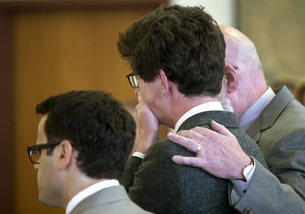 Attorney J.W. Carney puts his arm around Owen Labrie as he weeps after his verdict is read at Merrimack County Superior Court on Friday in Concord, N.H. Labrie, 19, was cleared of felony rape but convicted of misdemeanor sex offenses against a 15-year-old former classmate. (Geoff Forester/The Concord Monitor via AP)