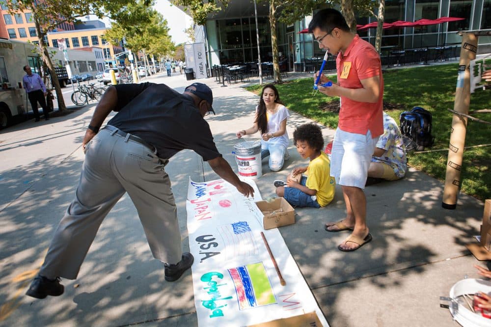 Students from MIT's first-ever integrated design and management program hit the streets of Cambridge with homemade instruments this week to busk for innovators 4 purpose, a Cambridge nonprofit that seeks to connect underprivileged children with creative thinkers. (Jesse Costa/WBUR)