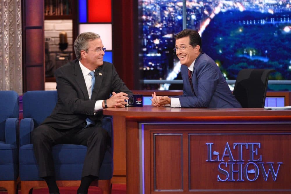 Stephen Colbert, right, talks with Republican presidential candidate Jeb Bush during the premiere episode of "The Late Show," Tuesday Sept. 8, 2015, in New York. Bush and actor George Clooney were the guests for Colbert's debut. (Jeffrey R. Staab/CBS via AP)
