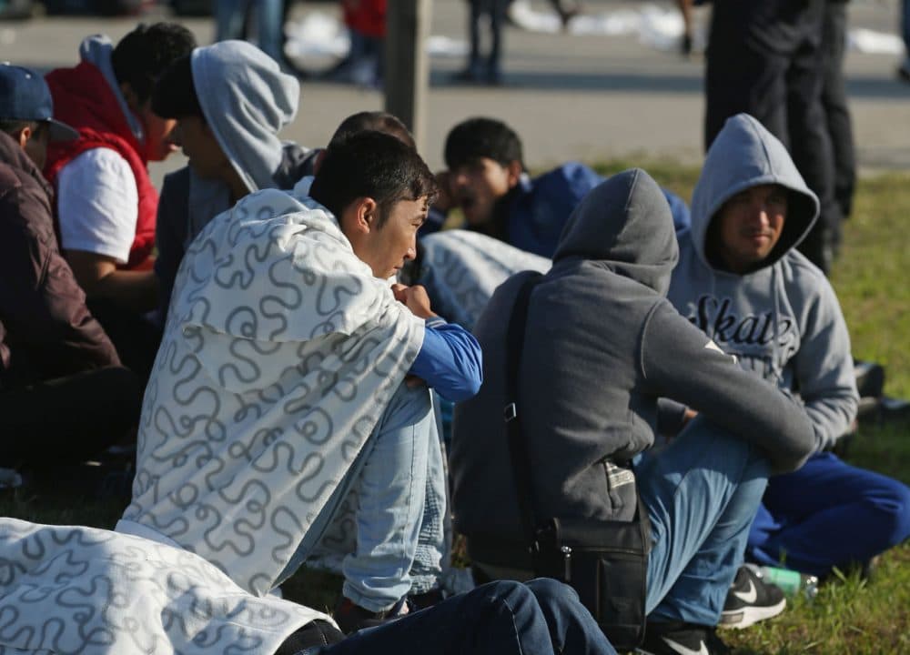 Migrants who had arrived on a chartered train from Munich wait to board buses to take them into Berlin at Schoenefeld train station on September 10, 2015. Thousands of migrants are currently arriving in Germany daily, most of them via trains from Austria and the Balkans. Germany is expecting to receive 800,000 asylum-applicants this year. (Sean Gallup/Getty Images)