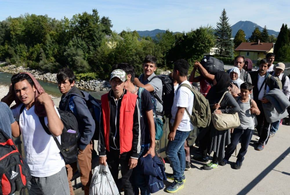 Refugees wait for police controls on a bridge crossing the border between Austria and Germany on Sept. 16, 2015. (Christof Stache/AFP/Getty Images)
