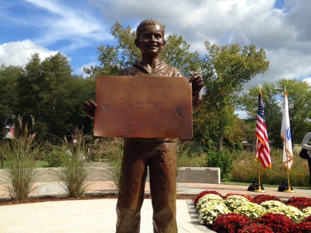 A life-size sculpture of Martin Richard, the youngest victim of the Boston Marathon bombing, is unveiled at Bridgewater State University on Saturday. (Kassandra Sundt/WBUR)