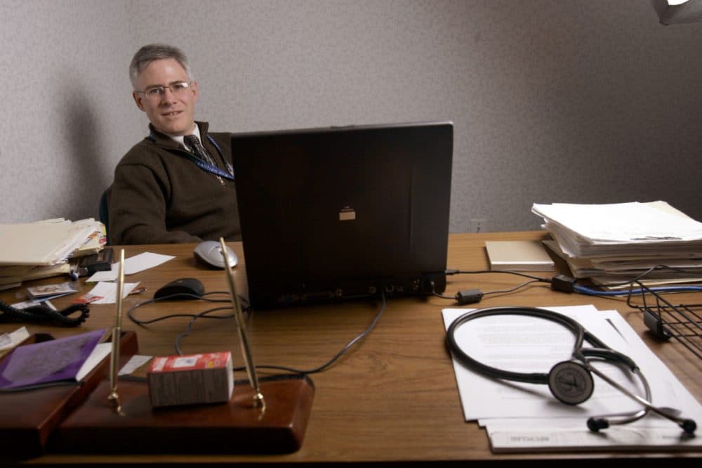 ** ADVANCE FOR SUNDAY FEB. 26 ** Dr. Eugene Heslin sits at a desk with his laptop on Thursday, Feb. 2, 2006, at his family practice in Saugerties, N.Y. From a laptop computer on his desk, he checks a cancer patient's hematology report from one lab and an X-ray report on another patient _ tasks that used to require phone calls or paper files. (AP Photo/ Jim McKnight)