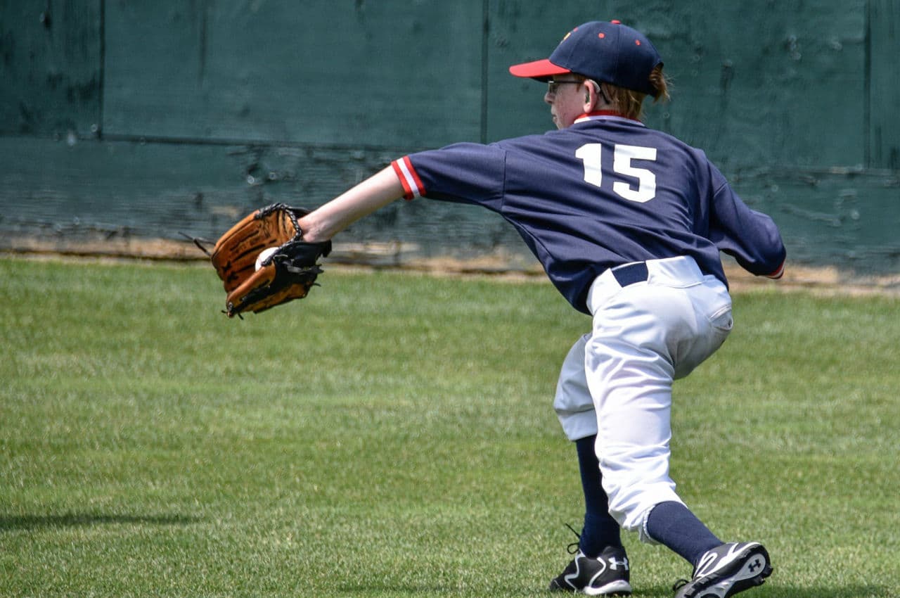 The author's son, Brendan Flanagan, 13, stabs a ground ball for the Lions during the first game of the week-long tournament. A brain-tumor survivor, Brendan was never supposed to be able to hit a baseball. He scored the team’s first run of the tournament by stealing home on a double-steal begun by his twin brother, Kevan, who was on first base. (Alex Belisle/Courtesy)
