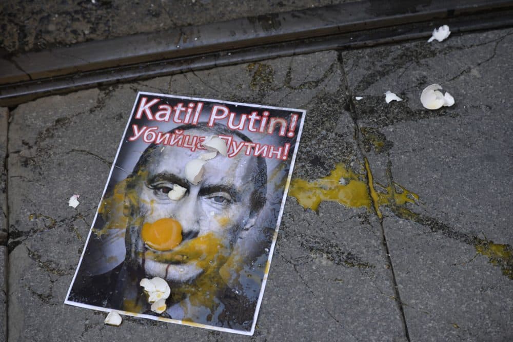 A picture depicting Russian President Vladimir Putin is splattered with eggs during a protest against Russian military operations in Syria, in Istanbul, Turkey, Saturday, Oct. 3, 2015. (AP)