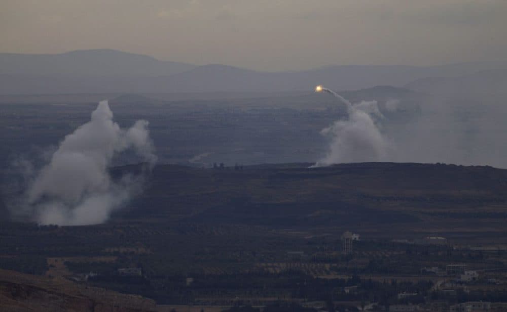 A picture taken from the hill village of Buqaata in the Israeli-annexed Syrian Golan Heights shows flames and smoke ascending from alleged shelling by Syrian government forces on Islamic State group's positions near the Syrian village of Jubata al-Khashab on October 6, 2015. (Jalaa Marey/AFP/Getty Images)