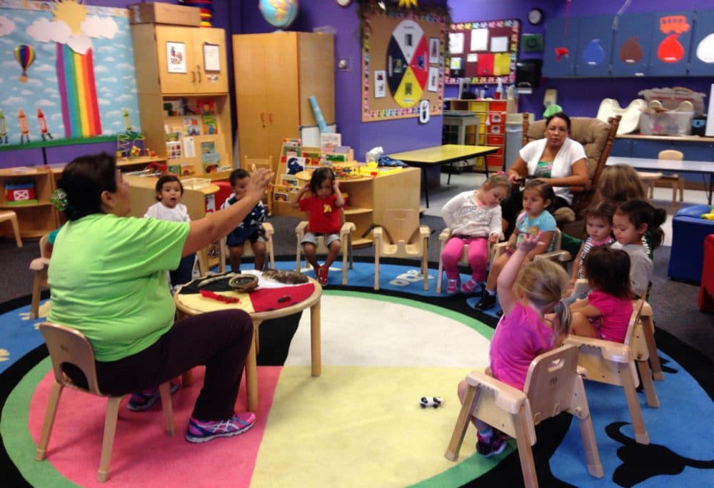 Two-year-olds at the Sasiwaans language immersion school in Mt. Pleasant get a lesson in the Native American tradition of smudging. (Emily Fox/Michigan Radio)