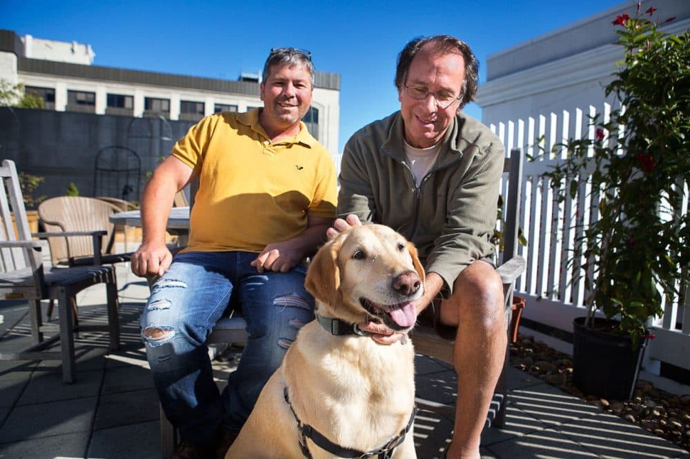 Dog rescuer Greg Mahle, left, sits outside WBUR with author Peter Zheutlin, who's written about Mahle's rescue efforts -- which include Zheutlin's dog Albie. (Jesse Costa/WBUR)