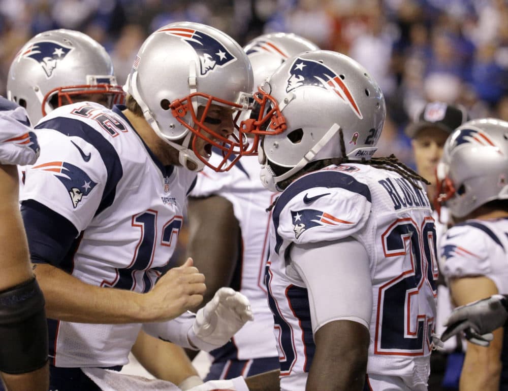 Patriots running back LeGarrette Blount (29) celebrates a touchdown with quarterback Tom Brady (12) in the second half of an NFL game against the Indianapolis Colts in Indianapolis, Sunday. (John Minchillo/AP)