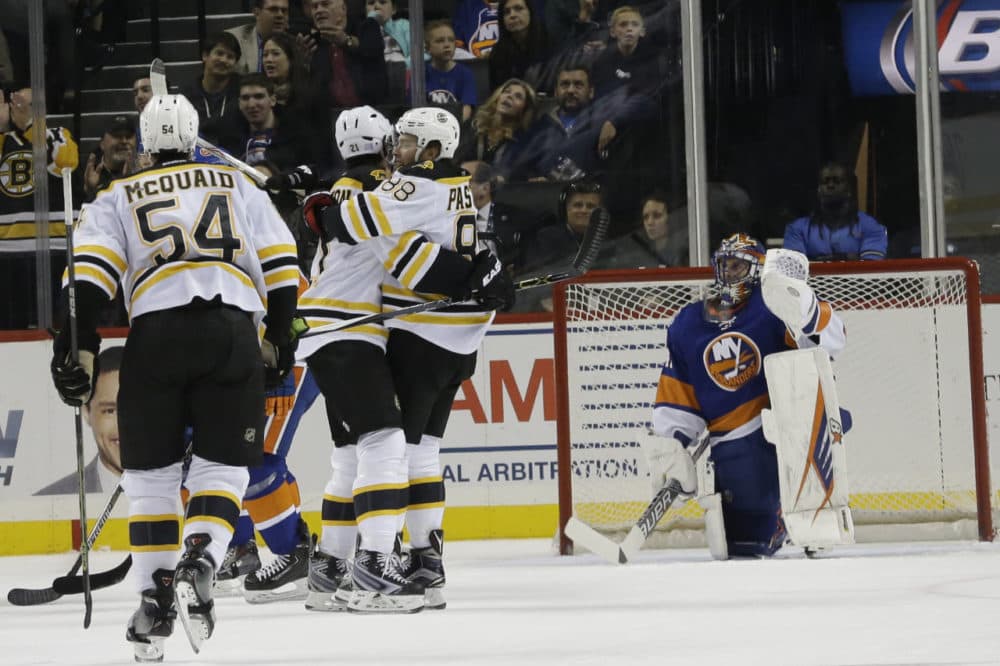 New York Islanders goalie Jaroslav Halak, right, reacts as Boston Bruins left wing David Pastrnak (88) celebrates with teammates after scoring a goal during the game's second period Friday in New York. (Mary Altaffer/AP)