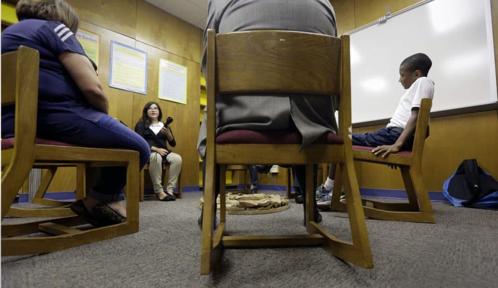 Two seventh graders discuss a recent conflict that they resolved through restorative justice, which included teachers and students gathering in circles for discussions, at Ed White Middle School, Friday, Oct. 16, 2015, in San Antonio. Philip Carney said that three years after starting a restorative discipline program as principal of Ed White Middle School in San Antonio, out-of-school suspensions have dropped by 72 percent. (Eric Gay/AP)