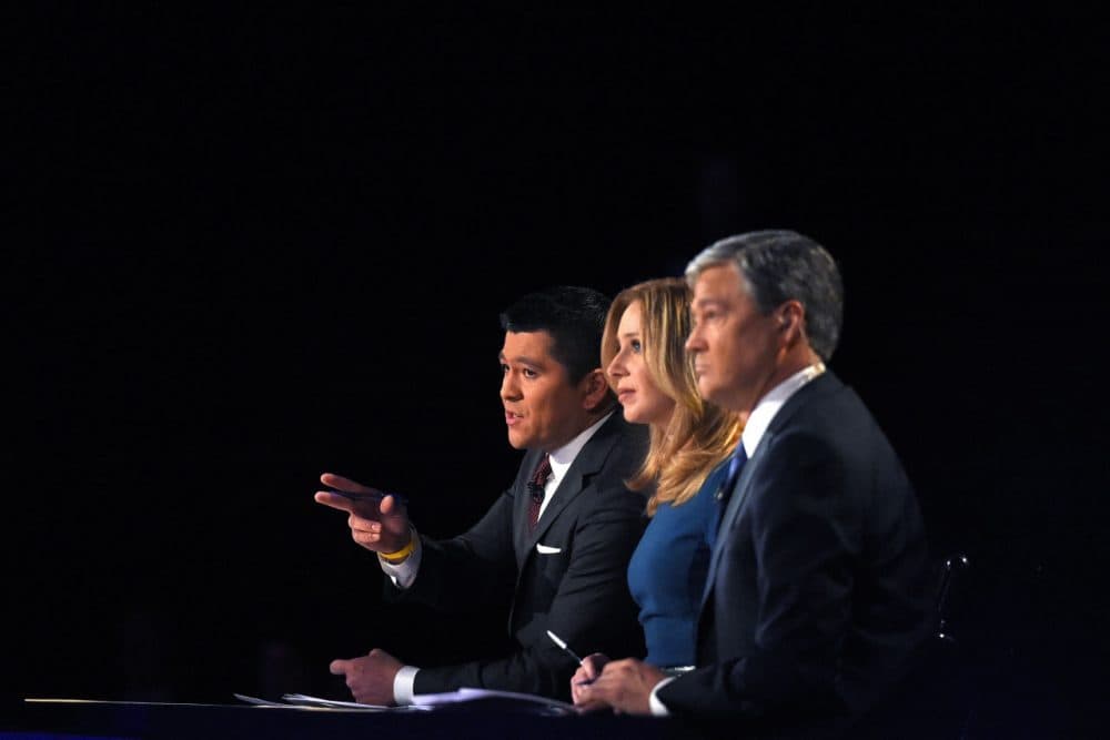 Debate moderators Carl Quintanilla, left, Becky Quick, center, and John Harwood appear during the CNBC Republican presidential debate at the University of Colorado, Wednesday, Oct. 28, 2015, in Boulder, Colo. (AP)