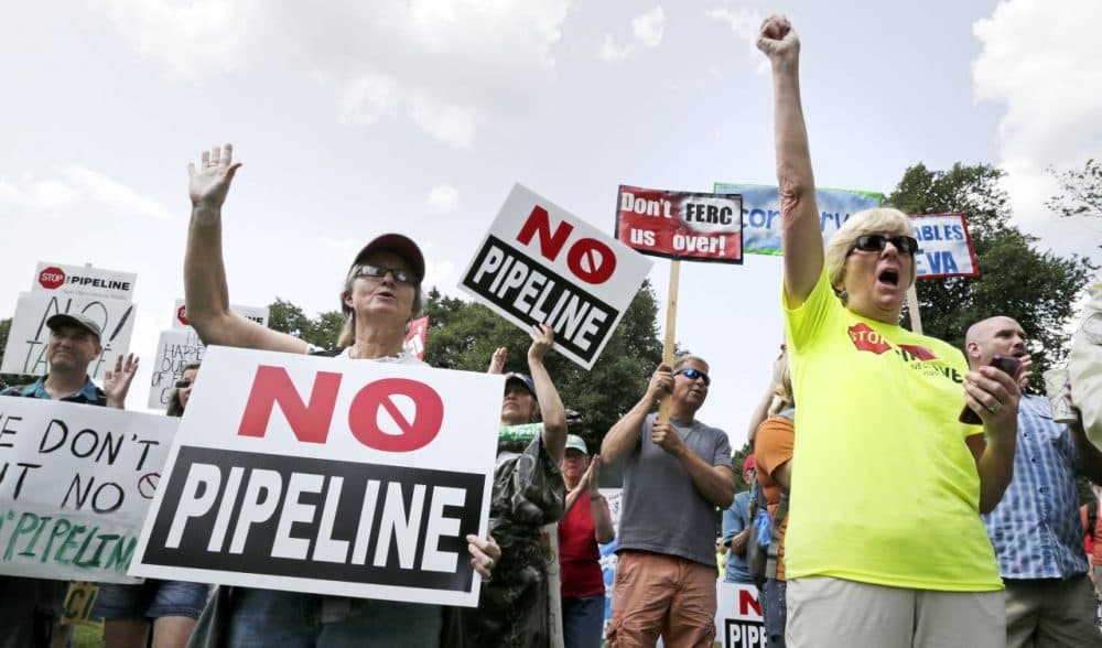 Opponents of Kinder Morgan's proposed natural gas pipeline, which was originally outlined to snake through 45 Massachusetts communities, protest on Boston Common on July 30, 2014. (Charles Krupa/AP)