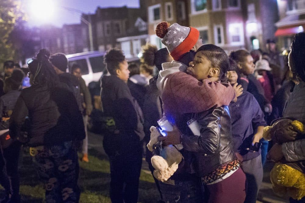 Pierre Stokes, the father of 9-year-old Tyshawn Lee, gets a hug during a candlelight vigil held outside his home in memory of his son on November 5, 2015 in Chicago, Illinois. Chicago Police Superitendant Garry McCarthy claims Lee was lured from a park into a nearby alley and executed because of his father's gang ties. Stokes denies being in a gang. (Scott Olson/Getty Images)