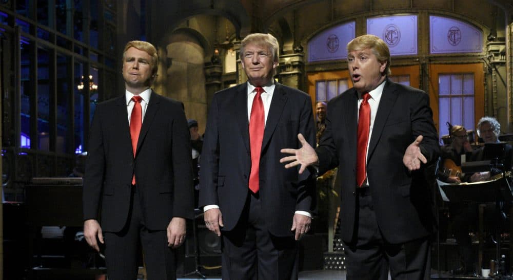 Taran Killam, left, Republican presidential candidate and guest host Donald Trump, center, and Darrell Hammond perform during the monologue on &quot;Saturday Night Live&quot;, Saturday, Nov. 7, 2015. Trump's 90 minutes in the &quot;SNL&quot; spotlight followed weeks of growing anticipation, increasingly sharp criticism and mounting calls for him to be dropped from the show. (Dana Edelson/ AP)