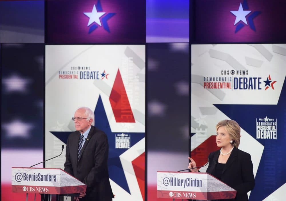 Democratic Presidential hopeful Hillary Clinton (right) speaks next to Bernie Sanders during the second Democratic presidential primary debate in the Sheslow Auditorium of Drake University on November 14, 2015 in Des Moines, Iowa. (Mandel Ngan/AFP/Getty Images)